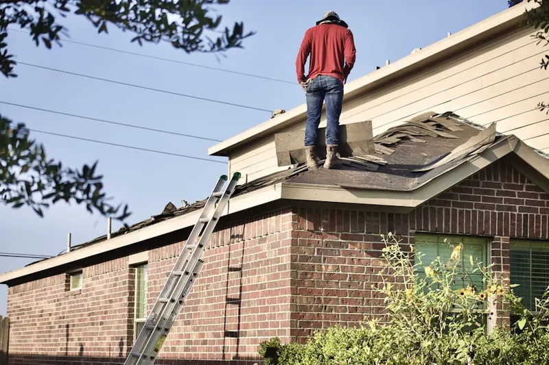 Professional roofer working on a residential roof in Del Mar Parkway